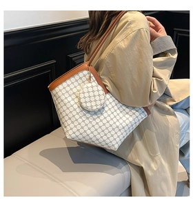 Detail of checkered tote bag and small round pouch with brown leather trim and strap
