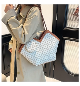 Detailed view of checkered tote bag and round pouch on model wearing a trench coat