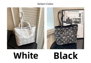 Detail view of plaid tote bags in black and white with slim straps and metal accents