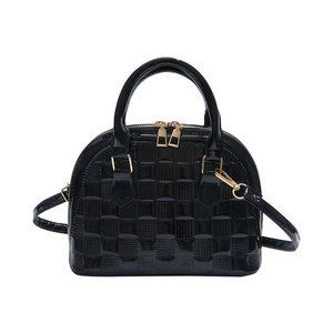 Glossy black shell bag with checkerboard embossing and gold hardware handles