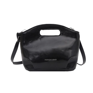 Chic black glossy bucket bag with cutout handles and Fashion & Bags text on white base
