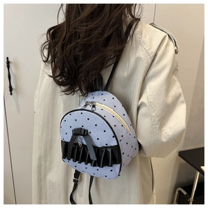 Detail of mini striped backpack with black heart print and decorative bow on the bottom