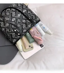 Spacious interior of a geometric floral tote bag showing daily essentials and large capacity