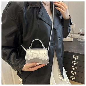 Silver metallic crocodile pattern mini crossbody bag styled with a high-fashion outfit