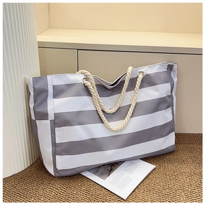 Close-up of grey and white striped canvas tote bag with thick cotton rope handles