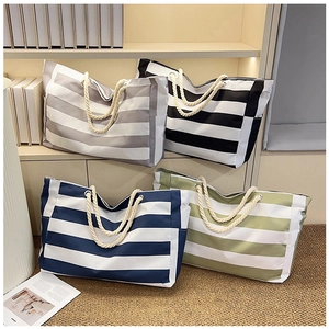 Detailed display of striped canvas tote bags in four colors with cotton rope handles