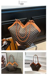 Detail of dark brown monogram tote bag with matching round pendant and V-shaped opening