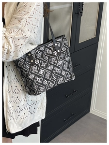 Detail of the woven pattern on a Chinese style tote bag with black shoulder strap