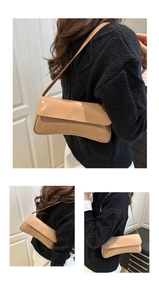 Detailed views of a glossy beige baguette shoulder bag showing sleek streamline design