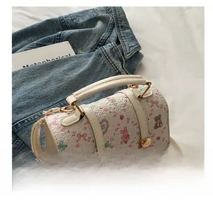 Close-up of white embossed crossbody bag with cute rabbit and bear cartoon prints