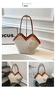 Detail of white monogram tote bag with V-cut edge and brown leather trim detailing