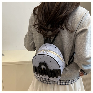 Detailed back view of a mini striped backpack with heart prints and black leather ruffles