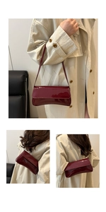 Close-up of wine red glossy patent leather shoulder bag with sleek rectangular flap design