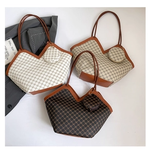 Flat lay of tote bags featuring vintage geometric patterns and leather trim details