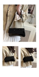 Macro shot of high-gloss black patent leather shoulder bag with sleek minimalist design