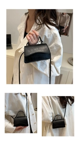 Close-up of mini black crocodile pattern PU leather crossbody bag with top handle