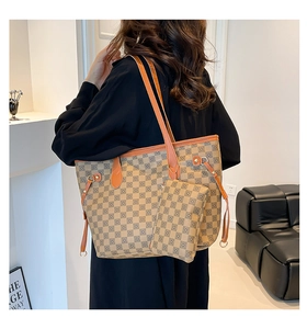 Detail of vintage geometric pattern tote bag and pouch worn by model in a stylish room