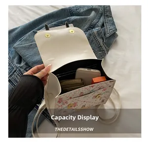 Internal capacity display of a white floral bear backpack showing essentials like a phone
