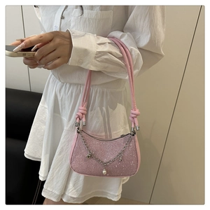 Detailed shot of pink sequin shoulder bag with silver chains and star charm