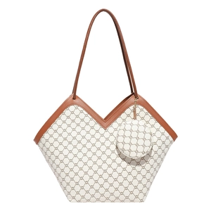 Chic monogram tote bag with V-shaped opening and matching round charm accessory