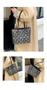 Detail of geometric pattern tote bag featuring maze print and floral accents on durable fabric