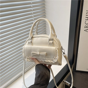 Cream chic bowling bag with lace bow detail, stylish shoulder and crossbody style
