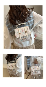 Detail of tweed bow backpack with bear print and golden metal handle in cream white