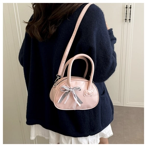 Detailed view of pink handbag with black white plaid bow and white lace trim detail