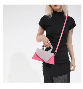 Detail of pink contrast shoulder bag with silver glitter flap and heart-shaped metal handle