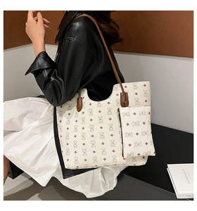 Detail of trendy tote bag and small pouch with bear pattern on stylish model