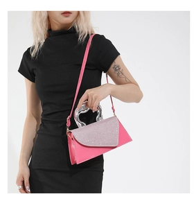 Detail of pink crossbody bag with sparkling silver rhinestones and a metal handle
