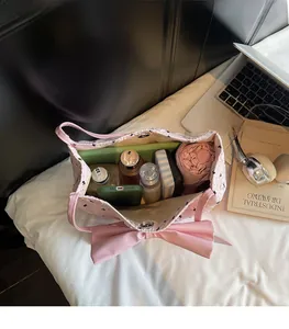 Pink quilted tote bag with large bow detail showing spacious interior for daily essentials