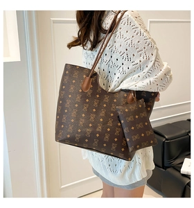 Detail shot of vintage brown tote bag with bear print and matching small pouch