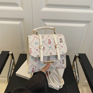 Cream white backpack with pink cartoon bear prints and gold hardware detail