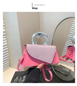 Close-up of pink crossbody bag with sparkling diamond flap and unique silver metal handle