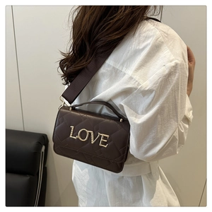 Détails du sac cylindre marron foncé avec logo LOVE doré et large bandoulière