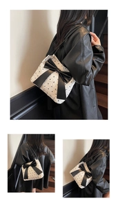 Detail of white bubble texture fabric with oversized black bow on a stylish shoulder bag