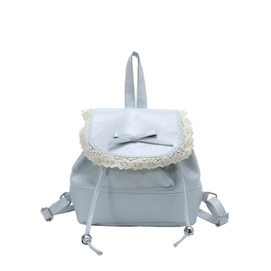 Light blue ballet style crossbody bag with white lace trim and bow on white background