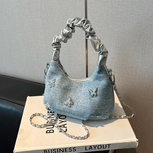 Blue denim crossbody hobo bag with silver butterfly charms and chain strap detail