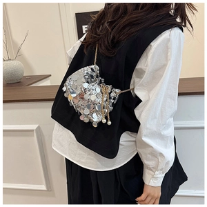 Detail of mini bucket bag with large silver sequins, gold chain and pearl accents