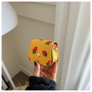 Detailed view of a yellow mini cherry wallet with gold snap button and metal chain strap