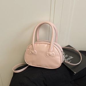 Pink bowling handbag with bow embossed detail and crossbody strap for women
