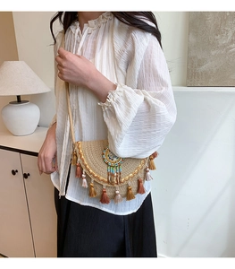 Detail of woven straw crossbody bag featuring colorful beads and boho fringe tassels