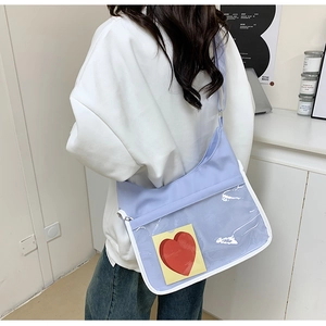 Detail of lavender crossbody bag with clear PVC pocket and adjustable fabric strap