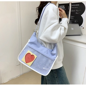 Detail of light purple school messenger bag with a transparent window for plush toys