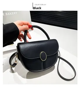 Detailed side view of black semicircular crossbody bag with oval golden metal buckle