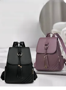 Detail of lychee pattern PU leather backpacks with tassels and metal rings