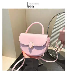Detailed view of pink vintage saddle bag with matte PU leather and gold oval metal buckle