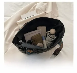 Top view of black quilted space cotton tote bag showing spacious interior with daily essentials