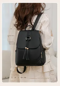 Detailed back view of a black PU leather backpack featuring fringe and a metal ring clasp